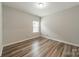 Bright bedroom with natural light and wood flooring, creating a cozy atmosphere at 1819 Lotus Ln, Denver, NC 28037