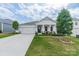 Charming single-story home featuring a two-car garage, landscaped front yard, and inviting covered front porch at 1819 Lotus Ln, Denver, NC 28037