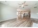 Bright living room featuring hardwood floors, and a view of the kitchen with stainless steel appliances at 1819 Lotus Ln, Denver, NC 28037