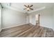Spacious main bedroom with tray ceiling, fan, and ensuite bathroom at 1819 Lotus Ln, Denver, NC 28037