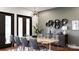 Dining room with a long table, modern chandelier, and access to the yard through french doors at 1935 Weddington Rd # 1, Matthews, NC 28104