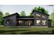 Rear exterior elevation featuring sleek siding, a covered patio, and expansive windows for natural light at 1935 Weddington Rd # 1, Matthews, NC 28104