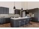 Modern kitchen featuring dark cabinetry, a large island with seating, and stainless steel appliances at 1935 Weddington Rd # 1, Matthews, NC 28104