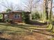 View of the backyard with a brick house and lush green lawn at 215 Bailey Ave, Rock Hill, SC 29732