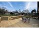 View from wooden deck with table and chairs, perfect for enjoying the backyard scenery at 2704 Silvers Ln, Albemarle, NC 28001