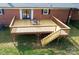 New wooden deck with railings and stairs, ideal for outdoor dining and relaxing at 2704 Silvers Ln, Albemarle, NC 28001