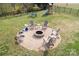 Aerial view of backyard fire pit area with chairs and a playset, perfect for outdoor enjoyment at 2704 Silvers Ln, Albemarle, NC 28001