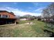 Large backyard featuring a fire pit with chairs and mature trees at 2704 Silvers Ln, Albemarle, NC 28001
