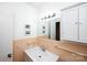 Bathroom with a well-lit mirror, updated fixtures, and classic tile, creating a clean and functional space at 2704 Silvers Ln, Albemarle, NC 28001