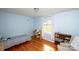 Charming bedroom with hardwood floors, a bright window, and light blue walls at 2704 Silvers Ln, Albemarle, NC 28001