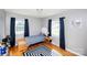 A cozy bedroom with hardwood floors, natural light, and blue accents, ideal for relaxation at 2704 Silvers Ln, Albemarle, NC 28001