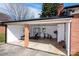 Open-air garage transformed into a home gym, with weightlifting equipment and stationary bikes at 2704 Silvers Ln, Albemarle, NC 28001