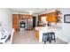 Functional kitchen with light wood cabinets, a stainless steel refrigerator, and a breakfast bar with seating at 2704 Silvers Ln, Albemarle, NC 28001