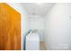 A practical laundry room with washer, dryer, and a convenient hanging rack for drying clothes at 2704 Silvers Ln, Albemarle, NC 28001