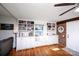 Bright living room with a brick accent wall, hardwood floors, built-in shelving, and comfortable seating at 2704 Silvers Ln, Albemarle, NC 28001