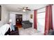 Cozy living room featuring hardwood floors, a ceiling fan, neutral-colored walls, and ample natural light at 2704 Silvers Ln, Albemarle, NC 28001