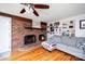 Charming living room with a brick fireplace, hardwood floors, neutral paint, and comfortable seating at 2704 Silvers Ln, Albemarle, NC 28001