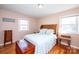 Relaxing main bedroom with natural light, wooden furniture, and hardwood floors for a serene atmosphere at 2704 Silvers Ln, Albemarle, NC 28001