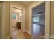 Hallway leading to an updated bathroom and bedroom, enhanced by hardwood floors at 28714 Nc Hwy 24/27 Hwy, Albemarle, NC 28001