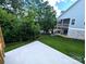 A backyard with green grass and woods, and a view of the home's deck from the yard at 29069 Low Country Ln # 602, Lancaster, SC 29720