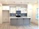 Bright kitchen featuring a center island, stainless steel appliances and white cabinets at 29069 Low Country Ln # 602, Lancaster, SC 29720