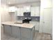 Modern kitchen with stainless steel appliances, kitchen island, and white cabinets at 29069 Low Country Ln # 602, Lancaster, SC 29720