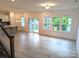 Open floor plan with hardwood floors connecting the kitchen and living room with large windows at 29069 Low Country Ln # 602, Lancaster, SC 29720