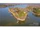 Picturesque aerial view of lake home with docks, nestled on a peninsula with lush greenery at 340 Topsail Rd, Salisbury, NC 28146