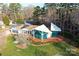 Lakefront property featuring solar panels, a unique architectural design, and well-manicured landscaping at 340 Topsail Rd, Salisbury, NC 28146