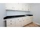 Cozy bar area featuring ample cabinet space, a sink, black countertops, and hardwood floors at 340 Topsail Rd, Salisbury, NC 28146