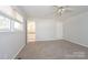 A bedroom with carpeted flooring and view into en-suite bathroom with a window at 340 Topsail Rd, Salisbury, NC 28146