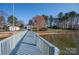 Scenic view of the dock leading to the house with waterfront living, lush greenery, and mature trees at 340 Topsail Rd, Salisbury, NC 28146