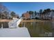 Scenic view of the dock leading to the house with waterfront living, lush greenery, and mature trees at 340 Topsail Rd, Salisbury, NC 28146