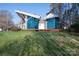 Modern home with striking architectural elements, blue glass, wooden deck, and landscaped lawn at 340 Topsail Rd, Salisbury, NC 28146
