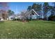 Modern home with striking architectural elements, blue glass, wooden deck, and landscaped lawn at 340 Topsail Rd, Salisbury, NC 28146