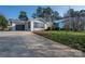 Modern home with striking architectural elements, blue glass, wooden deck, and landscaped lawn at 340 Topsail Rd, Salisbury, NC 28146