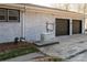 Exterior view of brick home featuring a generator and a two-car garage with dark doors at 340 Topsail Rd, Salisbury, NC 28146
