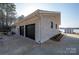 Spacious two-car garage with a white brick exterior and black garage doors near the lake at 340 Topsail Rd, Salisbury, NC 28146