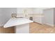 Modern kitchen featuring white cabinets, countertops, stainless steel appliances, and hardwood floors at 340 Topsail Rd, Salisbury, NC 28146