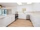 Modern kitchen featuring white cabinets, countertops, stainless steel appliances, and hardwood floors at 340 Topsail Rd, Salisbury, NC 28146