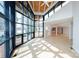 Open living room features a wall of windows, wood-planked ceilings, and hardwood floors at 340 Topsail Rd, Salisbury, NC 28146