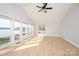 Bright living room featuring hardwood floors, vaulted ceilings, and wall of windows overlooking lake at 340 Topsail Rd, Salisbury, NC 28146