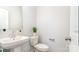 Bathroom with a pedestal sink, toilet, decorative plant, and a large framed mirror at 4046 Jenison Valley Ct, Charlotte, NC 28214