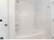 Bathroom featuring a shower-tub combo with white tile, and built-in shelves at 4046 Jenison Valley Ct, Charlotte, NC 28214
