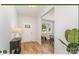 Bright entryway featuring wood flooring, a white front door, and a decorative table with a lamp at 4046 Jenison Valley Ct, Charlotte, NC 28214