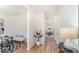 Hallway with wood floors, neutral walls, and a glimpse into a dining area, and a potted plant as decor at 4046 Jenison Valley Ct, Charlotte, NC 28214