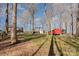 Expansive backyard with trees, and a charming red outbuilding at 412 Montana Dr, Gastonia, NC 28056
