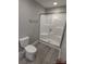Bathroom featuring a step-in shower with glass doors, neutral paint, and gray vinyl flooring at 4166 Saltwood Dr, Hickory, NC 28602