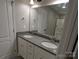 Bathroom with dual sink vanity featuring granite countertop and large mirror at 4166 Saltwood Dr, Hickory, NC 28602