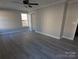 Spacious bedroom with ceiling fan, two big windows, and light gray walls and trim at 4166 Saltwood Dr, Hickory, NC 28602